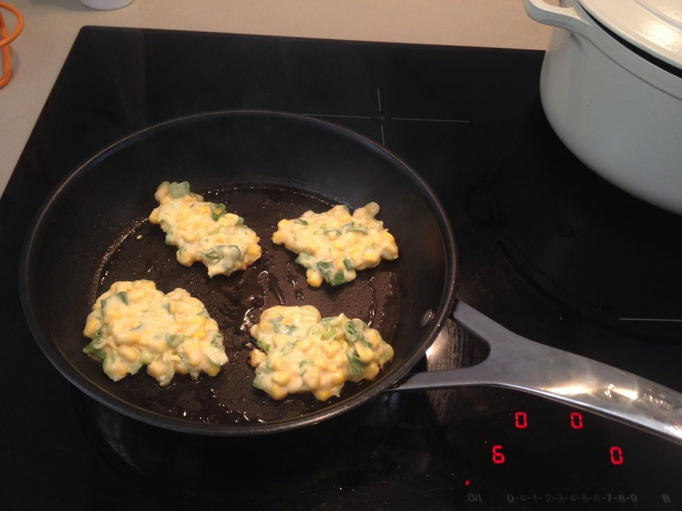 Preheat pan with 2 tablespoons of oil on medium to high heat. Place 4 portions of the fritter mixture into pan and spread evenly. Cook for 4 mins on each side until nicely brown