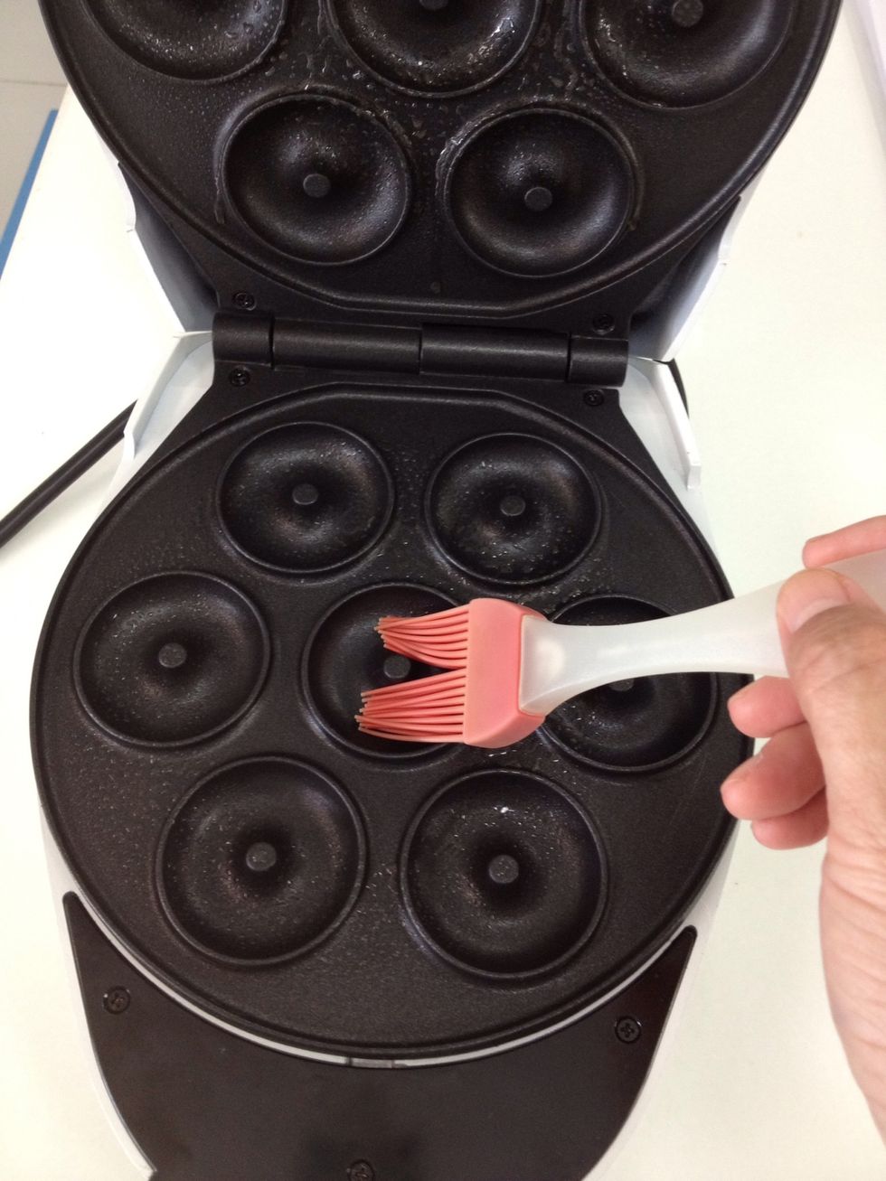 Preheat the doughnut maker and lightly grease both under and upper mold.