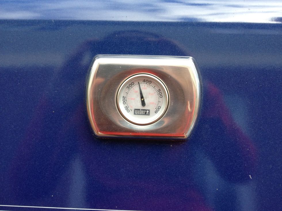 Preheat the grill to an average cooking temperature, then shut it off. Preheating helps to loosen up the grease buildup