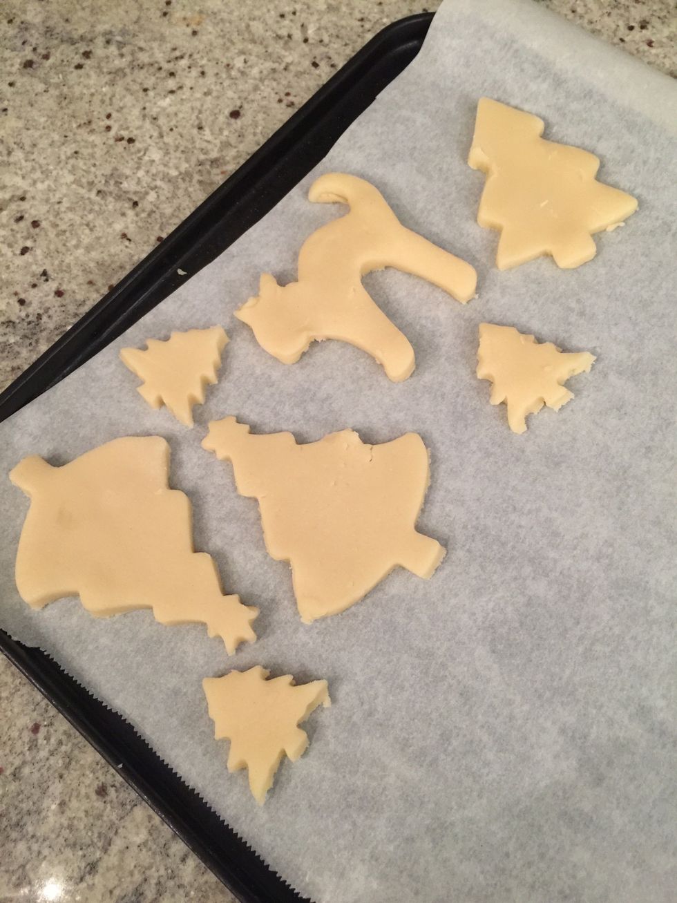 Preheat the oven to 350.\nPlace the cookies on a baking sheet. You will need to put parchment paper so the cookies wont stick to the sheet