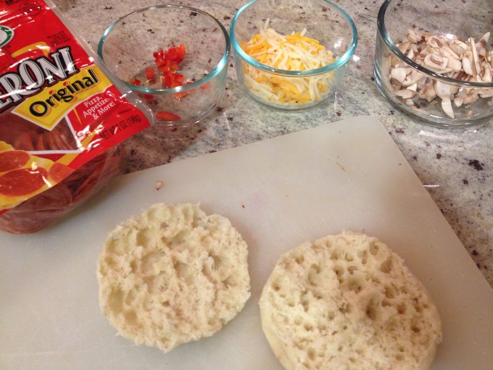Preheat the oven to 400 degrees. Slice the English muffins in half. Cut up the toppings and place in small bowls to make them easier for little fingers to grab.