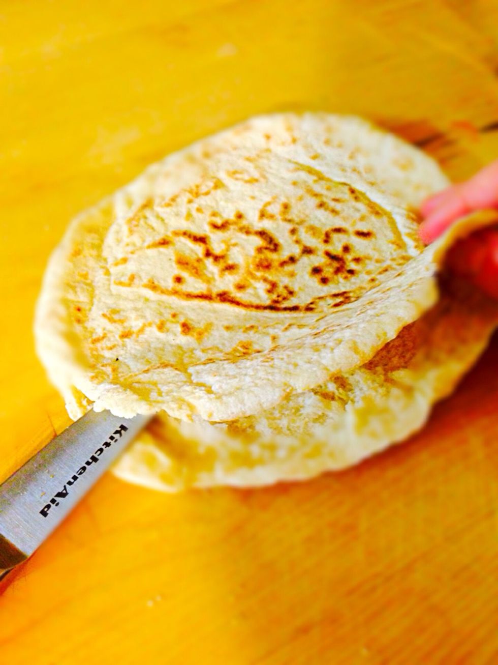 Preheat the oven to 400F. Cut pita bread between two layers