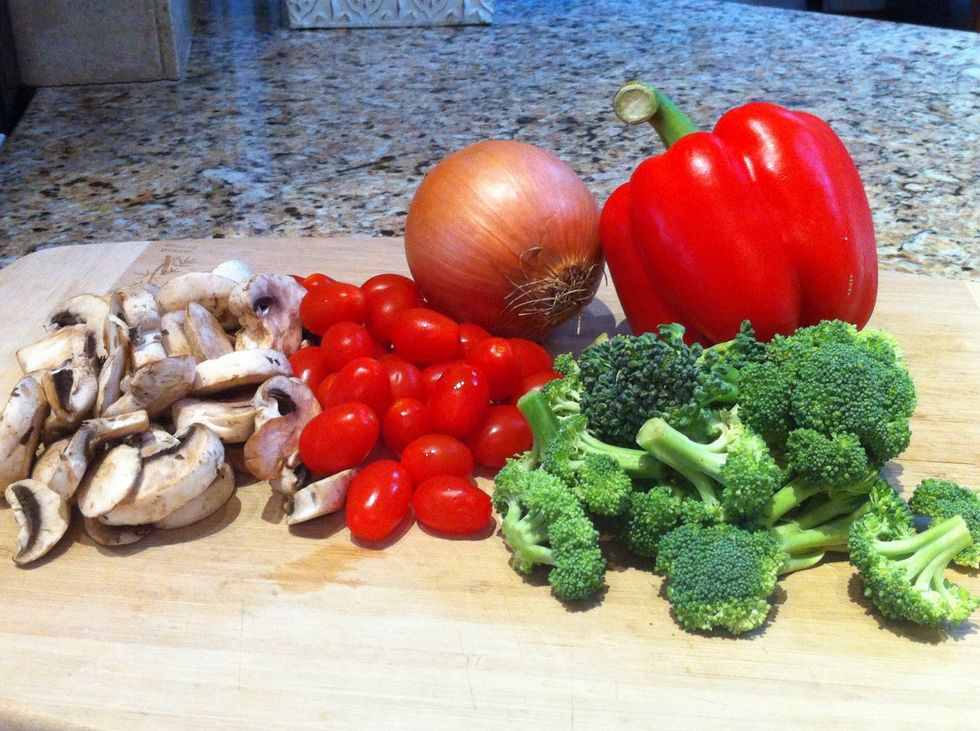 Preheat the oven to 450 degrees. I used mushrooms, grape tomatoes, broccoli, and red peppers. Chop or slice into uniform pieces. Vegetables that take longer to cook like onions should be smaller.
