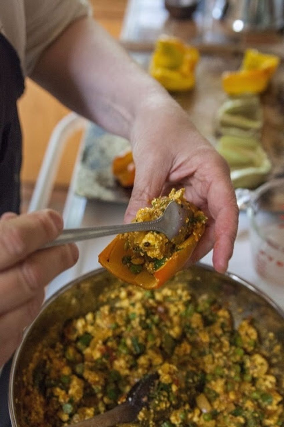 Preheat your grill to the highest setting. Brush a bit of oil on the grate to keep the peppers from sticking. Fill the baked pepper halves with the Paneer vegetable stuffing.
