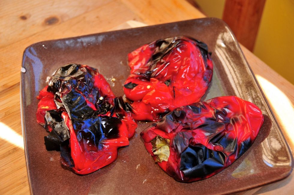 Preheat your oven or toaster oven to about 400 degrees. Place the peppers on a baking dish and roast until they are charred and the skin is pealing off. If you have a grill nearby, use it instead!