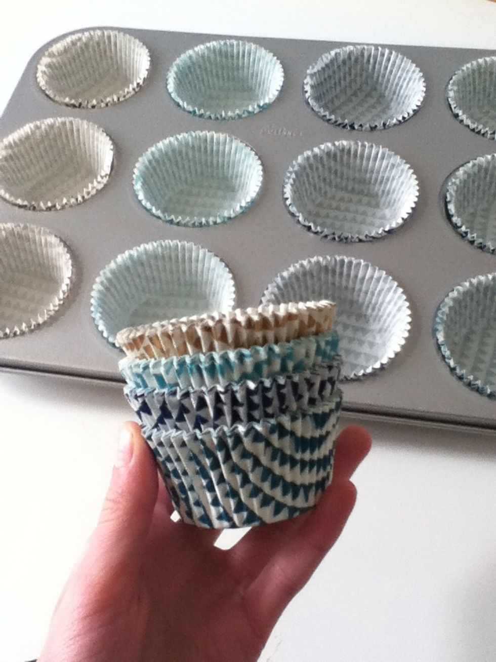 Preheat your oven to 200 degrees and line your baking tray with muffin cases.