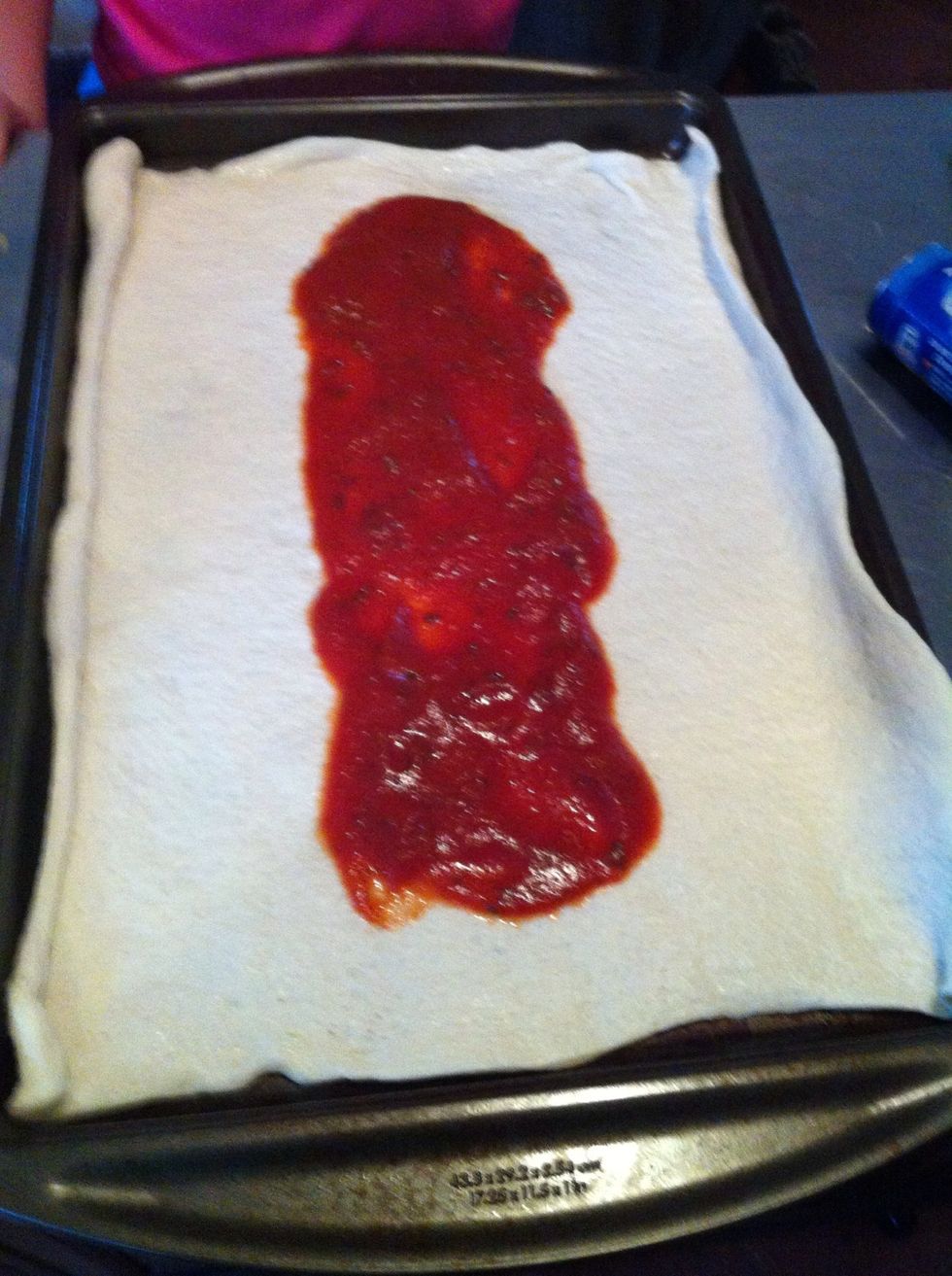Preheat your oven to 400 degrees then: Spread the pizza sauce over the center third of the dough on baking sheet.