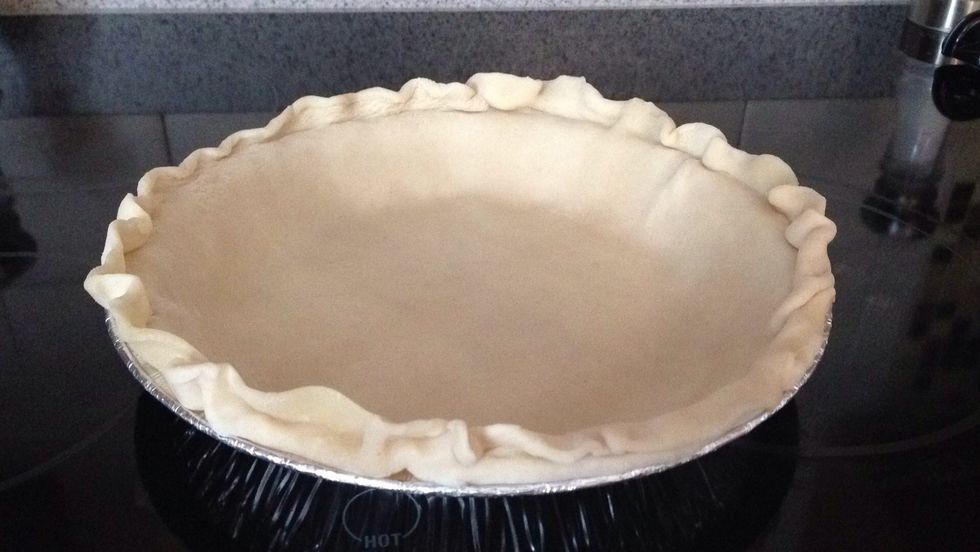Preheat your oven to 450 degrees. Spread your pie crust in a 9" pan while the oven is preheating.