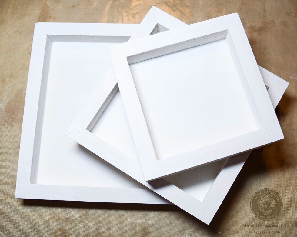 Prep Archival Case Wood Trays with white gesso. Once dry, glue printed backgrounds and add Dresden trim. Accent with heat embossing and spray mists.