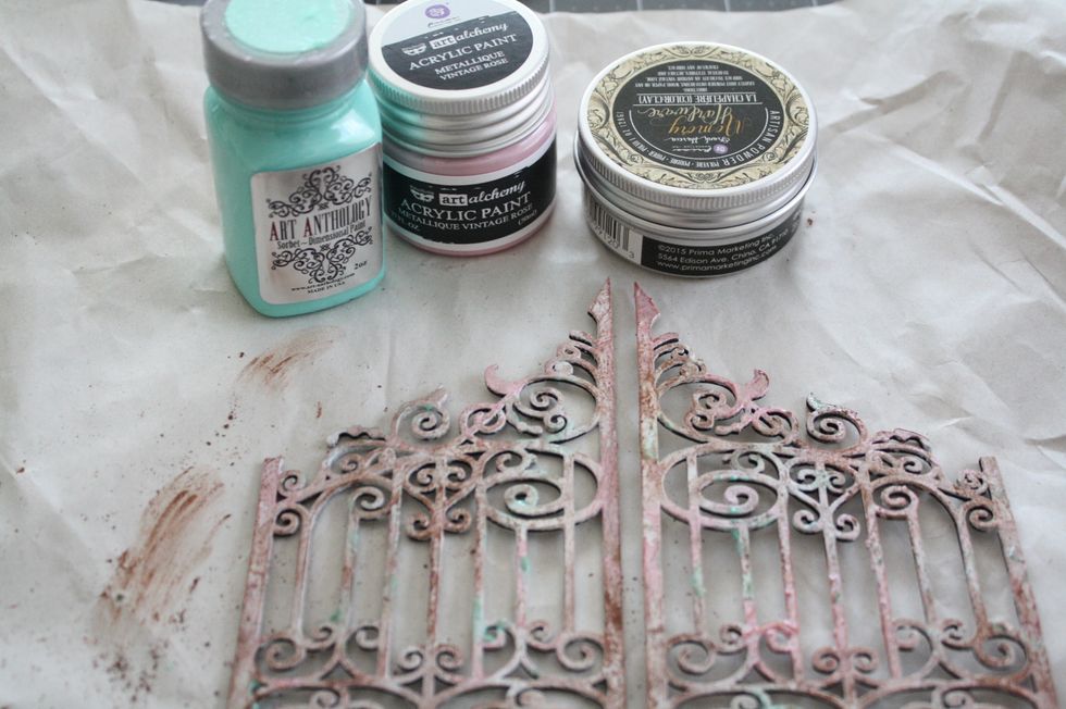 Prep your BFS Chipboard gate using items from the Mediums-Add on. First paint with gesso, using the dimensional paint and acrylic paint dab in random areas. when dry rub on a bit of Artisan Powder