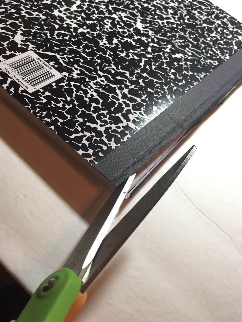prep your composition book by using scissors or a metal ruler and exacto to remove both the front and back covers. LEAVE a portion of the spine in place.