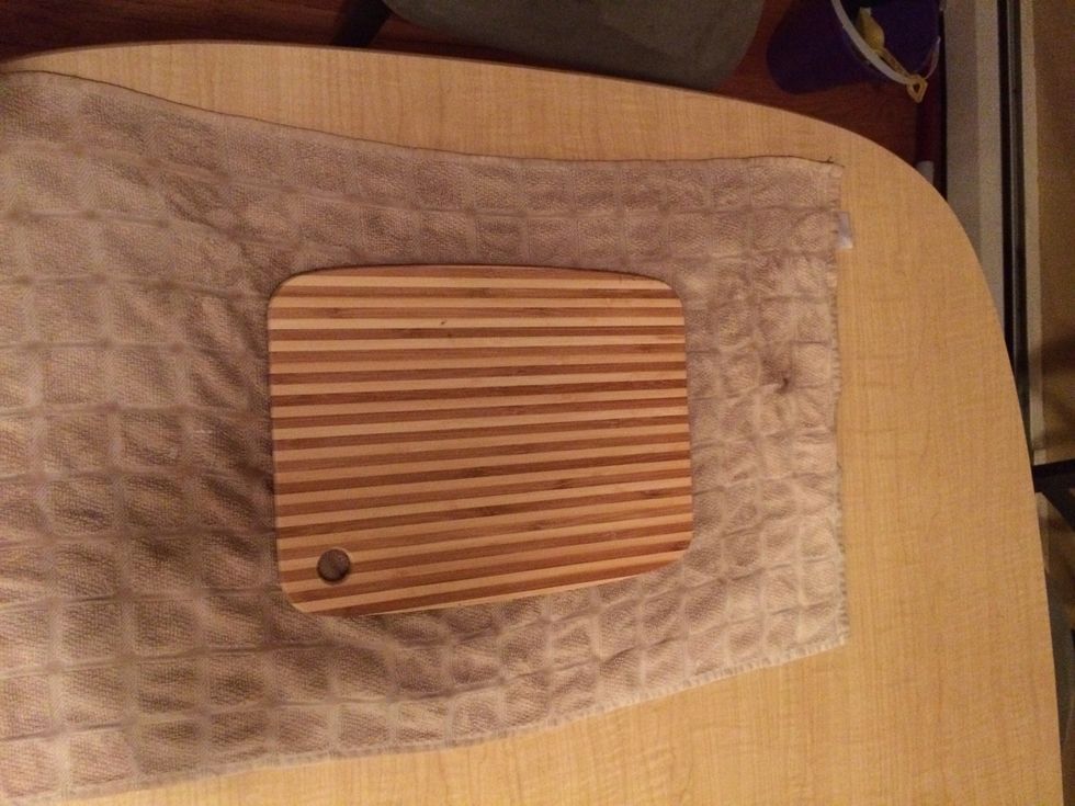 Prep your cutting board by placing a damp towel underneath to prevent board from moving or slipping while working.