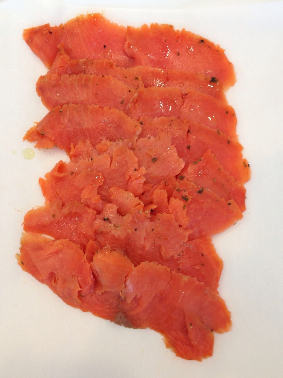 Prep your smoked salmon by adding a little pepper.