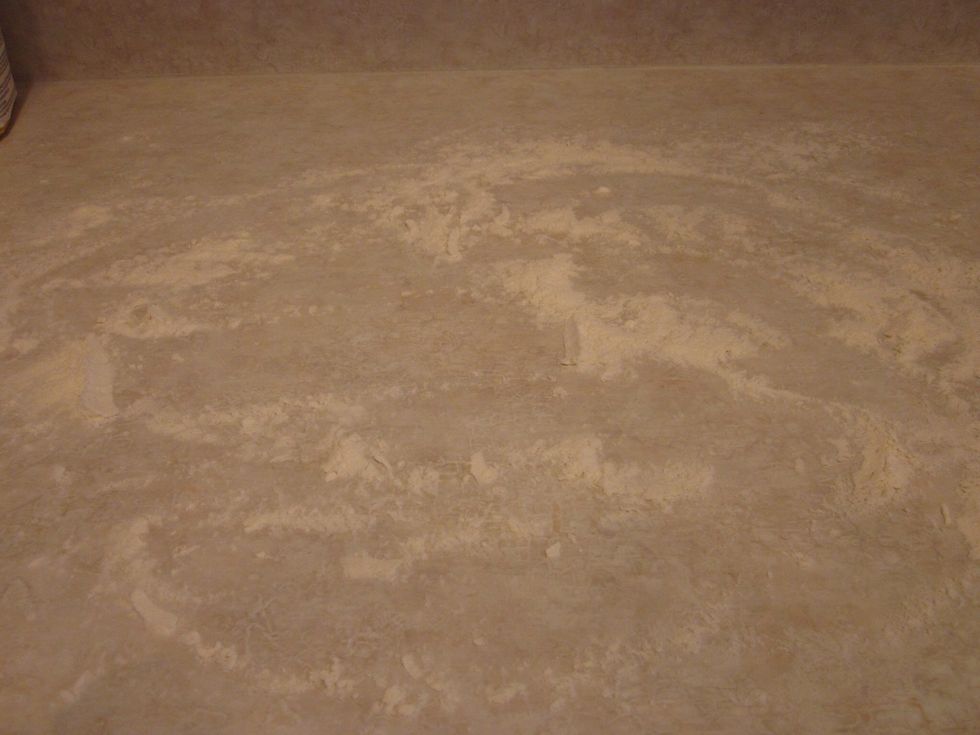 Prep your workplace for kneading. Spread some white flour down to prevent it from sticking. Get some on your hands too