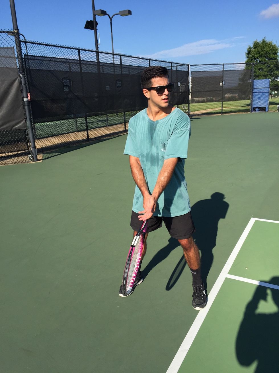 Preparation: align front foot 45 degrees past clockwise to aiming spot, as your left foot faces the target. Position yourself right behind the baseline, near center mark and crosscourt to intended box