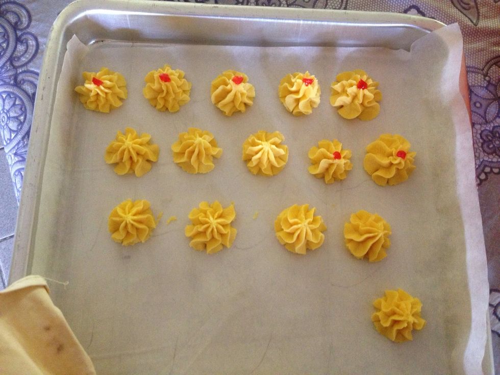 Prepare a baking sheet on a shallow and wide baking tray. Pipe them out like this. (Sorry, wasn't able to snap how the piping process looks like as i was doing it alone. I only have 2 hands)