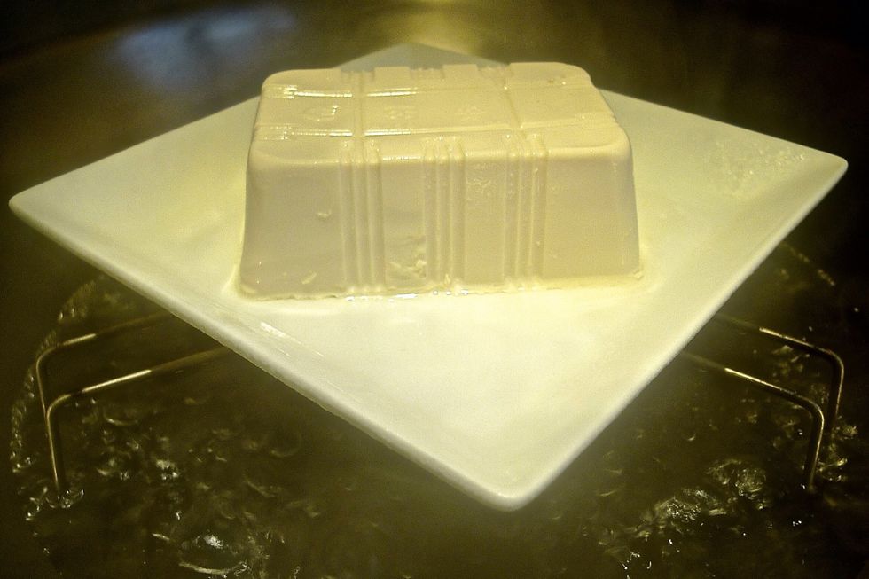 Prepare a steamer. Then steam the bean curd at high heat for 5 minutes. Remove from steamer, pour away excess water and set aside.