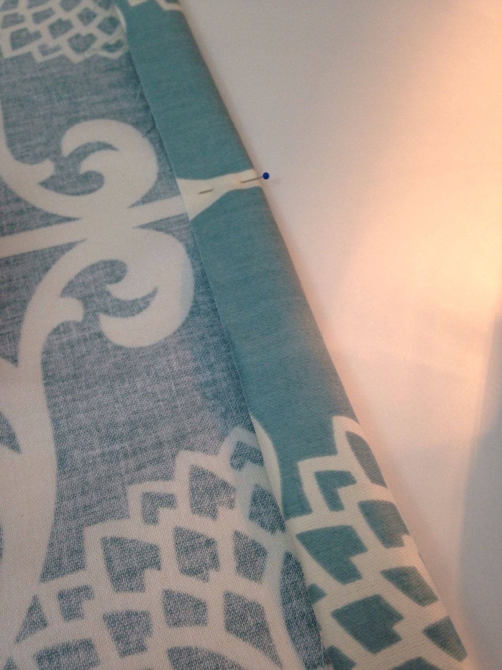 Prepare and pin a 1" hem on one long side of your smaller pieces of fabric.