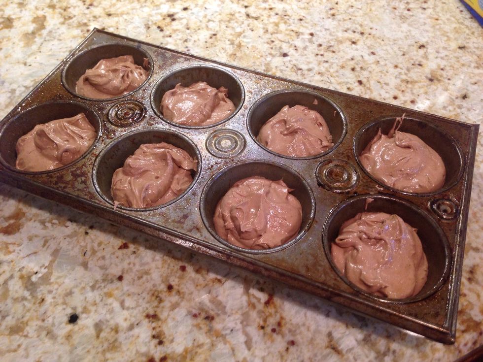 Prepare cake mix according to package directions. Do not use cupcake liners. Coat pan with cooking spray. Divide batter among the cups in the pan and bake according to package directions.