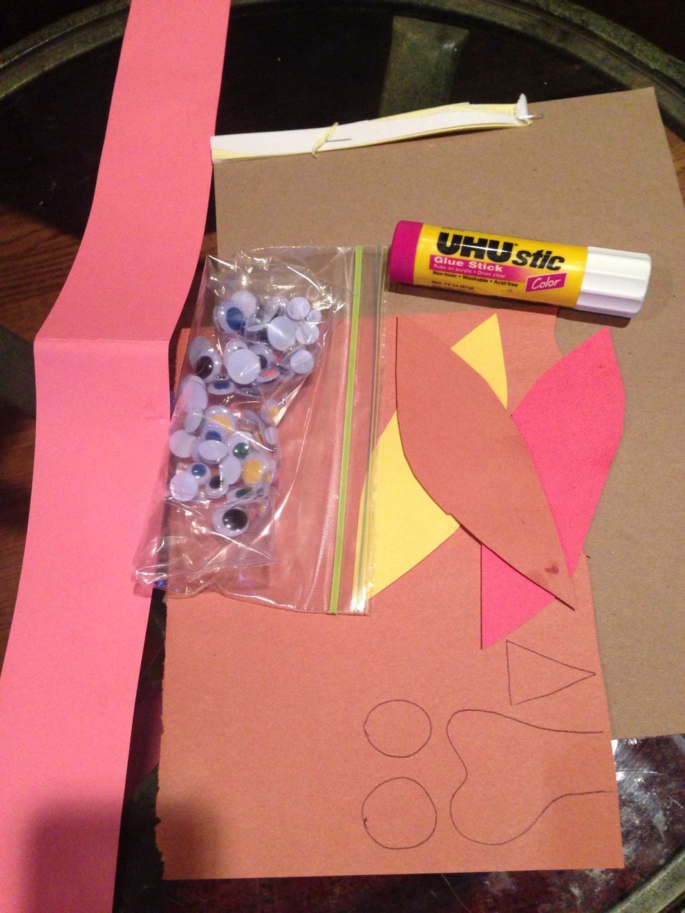 Prepare color paper band for the length log your head, cut out feather and parts.