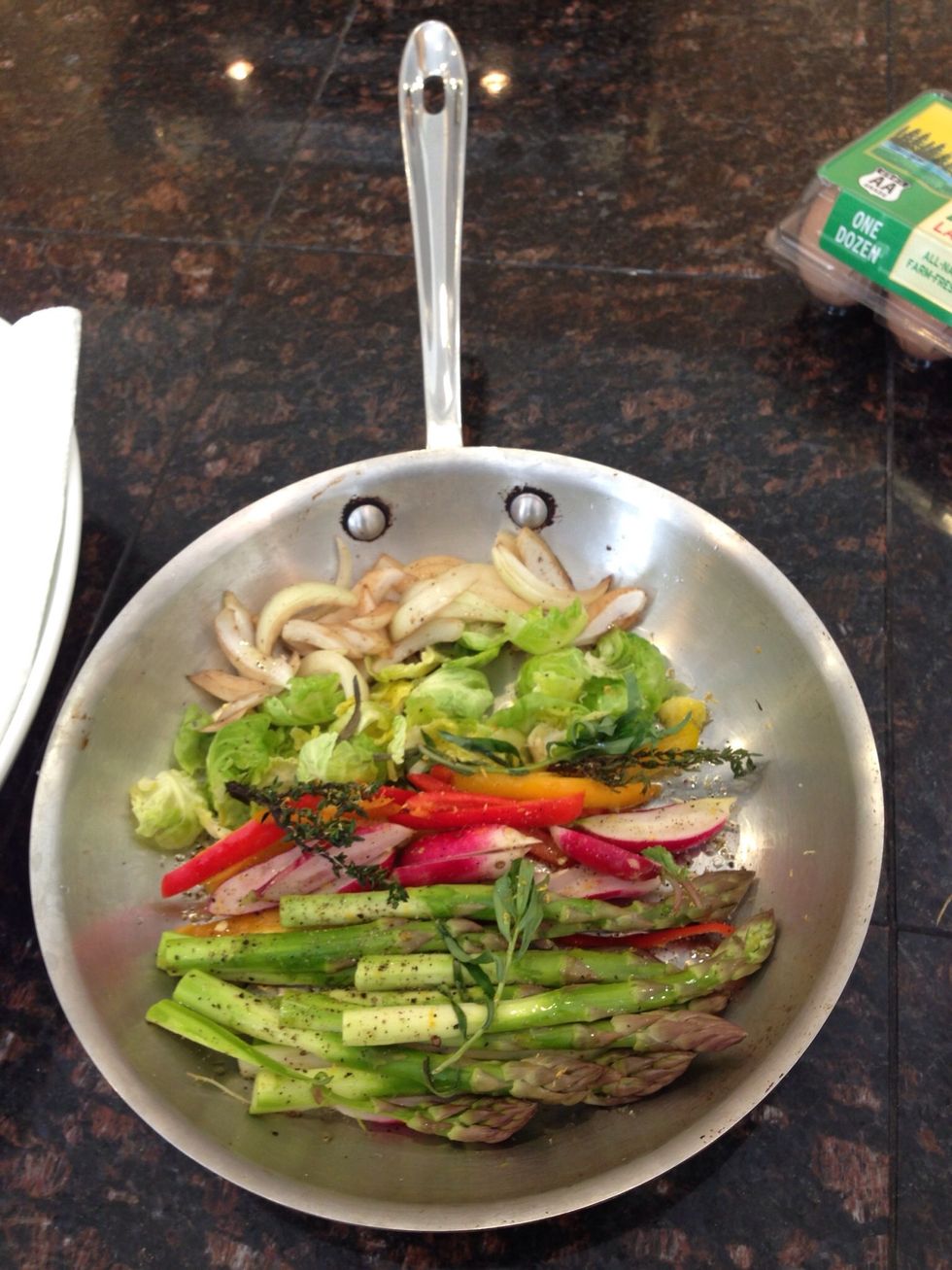 Prepare fresh veggies in a saucepan by chopping and adding a little salt, pepper, and grapeseed oil.