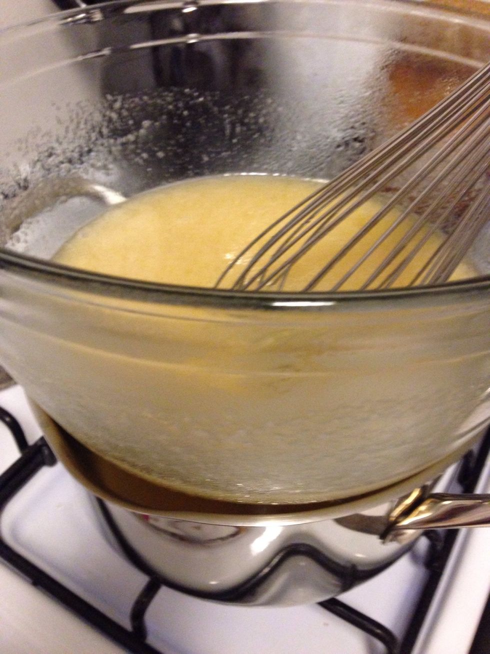 Prepare frosting! Whisk egg whites, sugar, and cream of tartar in large bowl and place over simmering double boiler and whisk for 6 minutes non-stop or until sugar is completely dissolved