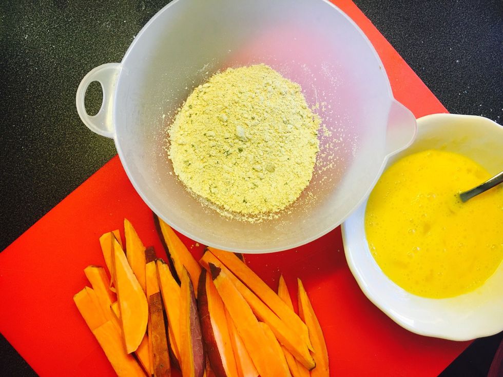 Prepare ingredients. Chop sweet potato into sticks. Put flour and spices in one bowl and egg in the other.
