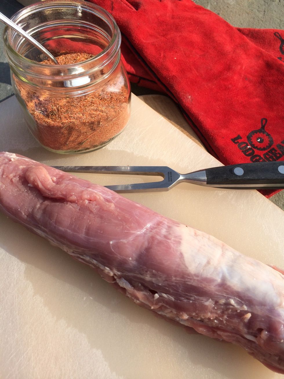 Prepare tenderloin, remove from packaging, drain, rinse and trim off any unnecessary fat. Take the pork, rub, cutting board, grill fork and tongs and anything else you need to prepare your grill.