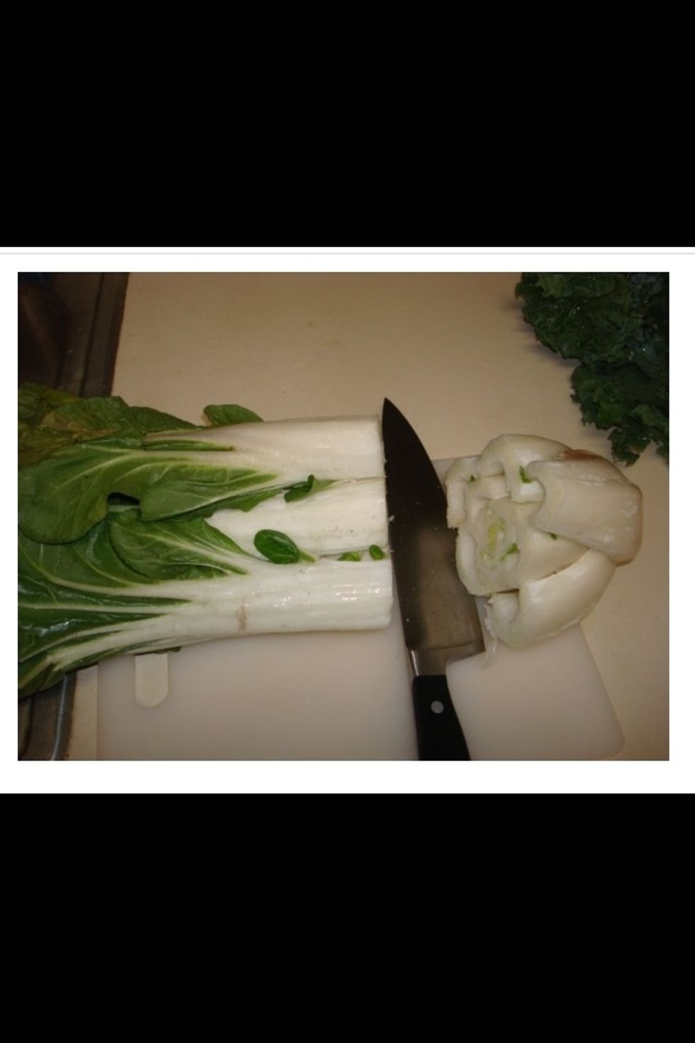 Prepare the bok choy by first removing the base of the plant.  This can be discarded.