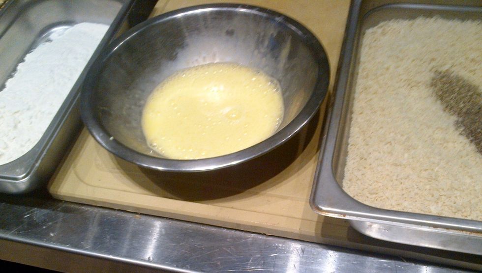 Prepare the breaking station by whisking eggs together in a bowl. Have flour ready in separate bowl.