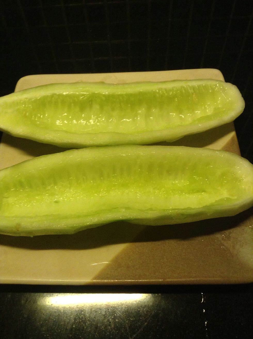 Prepare the cucumber. Cut it into half and then scrape the middle part.