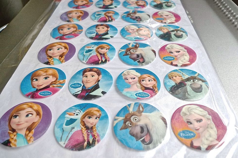 Prepare the Disney Frozen edible photo cupcake toppers.