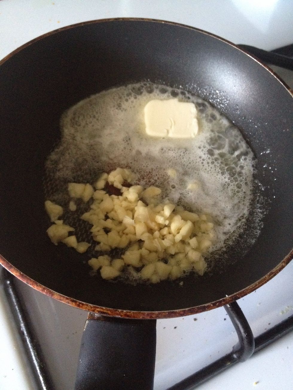 Prepare the garlic sauce using a saute pan on medium to low heat. Add the butter into the pan and when it melts, add the garlic and saute until aromatic but not browned.