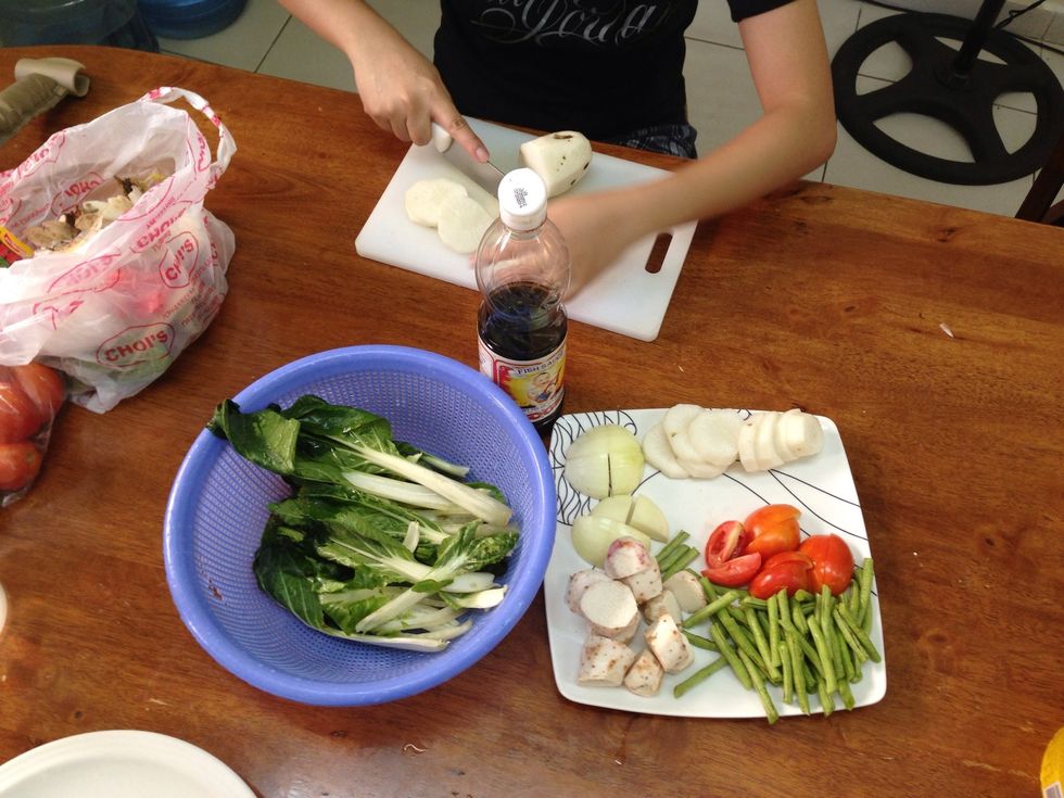 Prepare the ingredients. Onions, taro, string beans, pechay, radish, & siling labuyo.