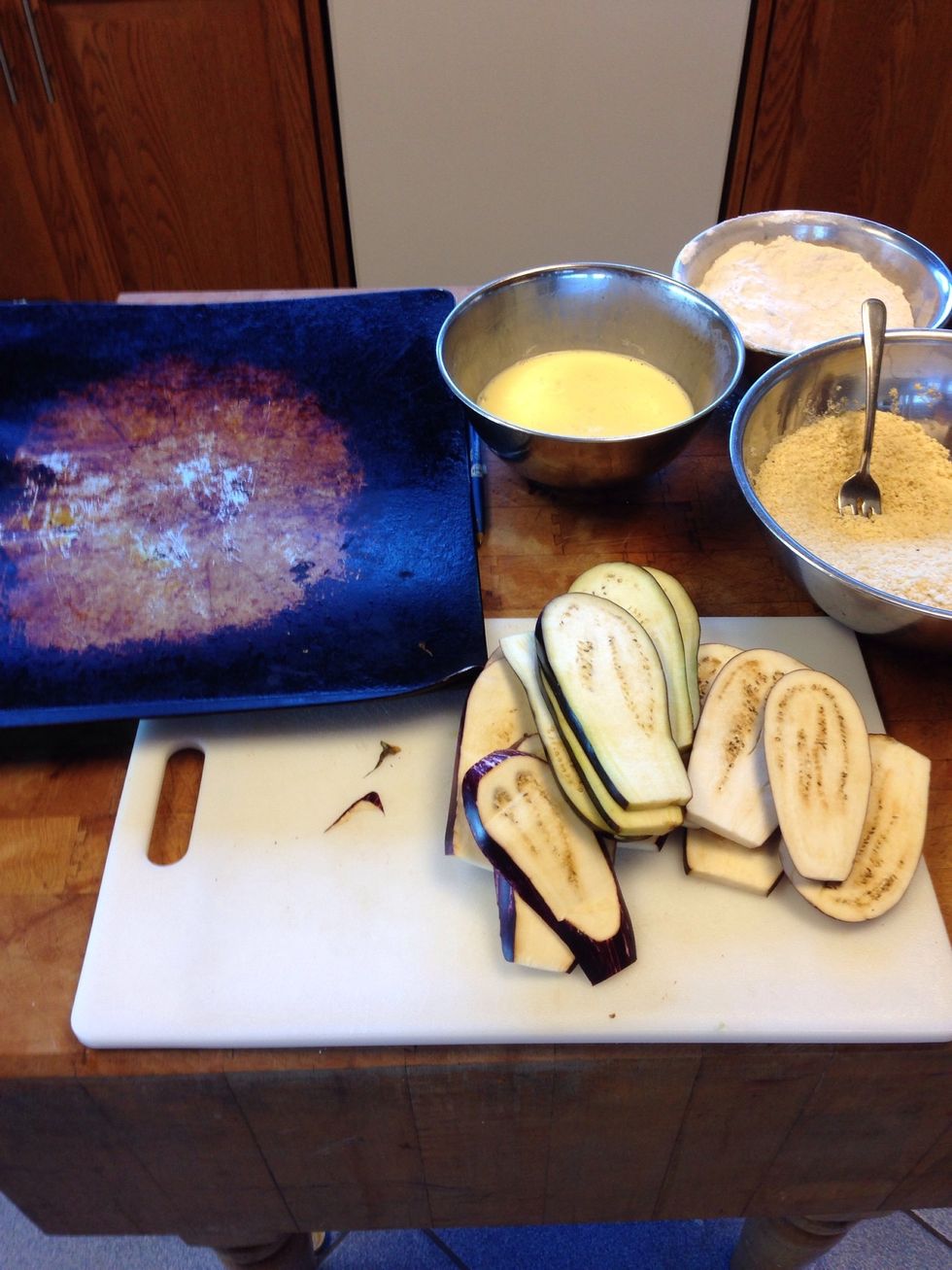 Prepare the station to coat the eggplant (have a bowl of flour as well) and have a baking sheet to place the coated egg plants