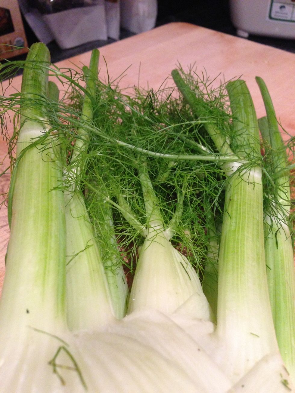 Prepare to cut the fronds off your fennel. No need to make them pretty we'll be blending them shorty!