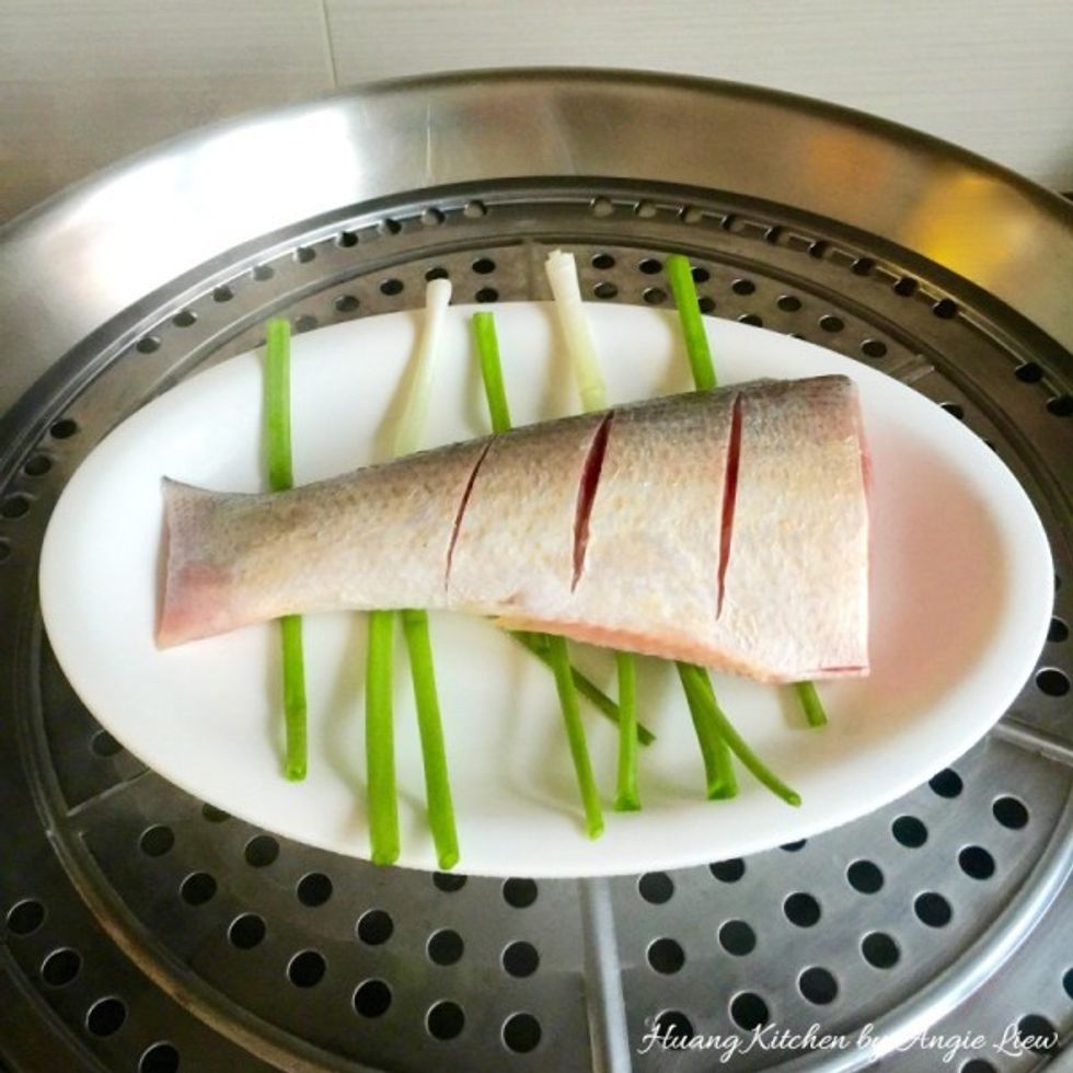 Prepare to steam the fish by first boiling some water in steamer. Then add in the fish.
