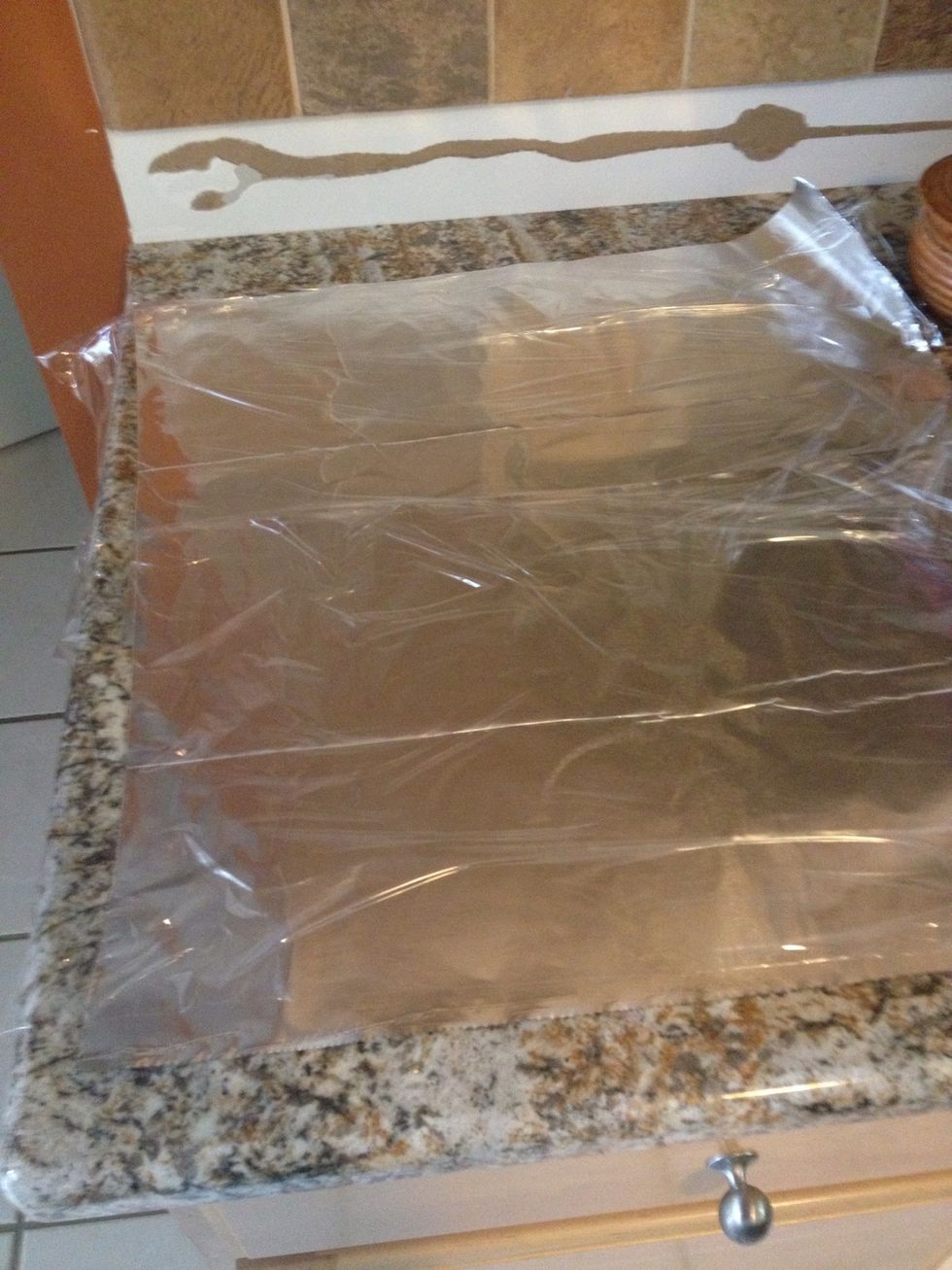 Prepare two pieces of aluminum foil with two pieces of Saran Wrap on top. This will be used later.
