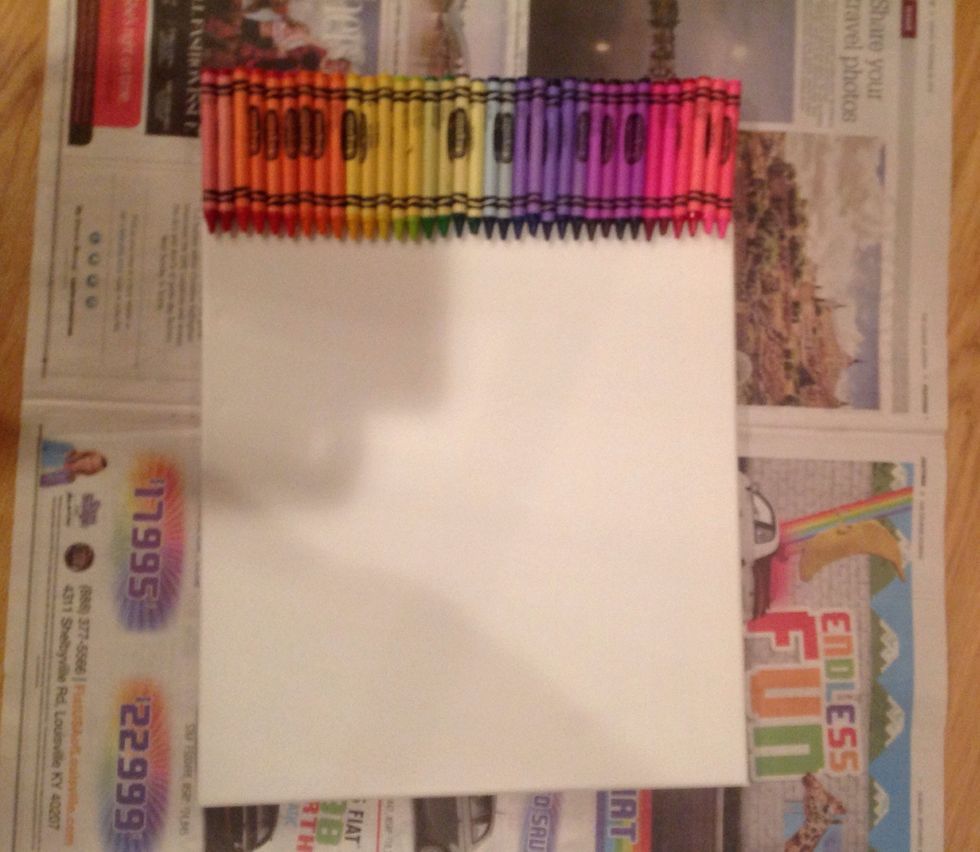 Prepare your area, with newspaper in case the crayons splatter while you are melting them. Tilt your canvas against a wall so when you start melting your crayons they drip down the canvas.