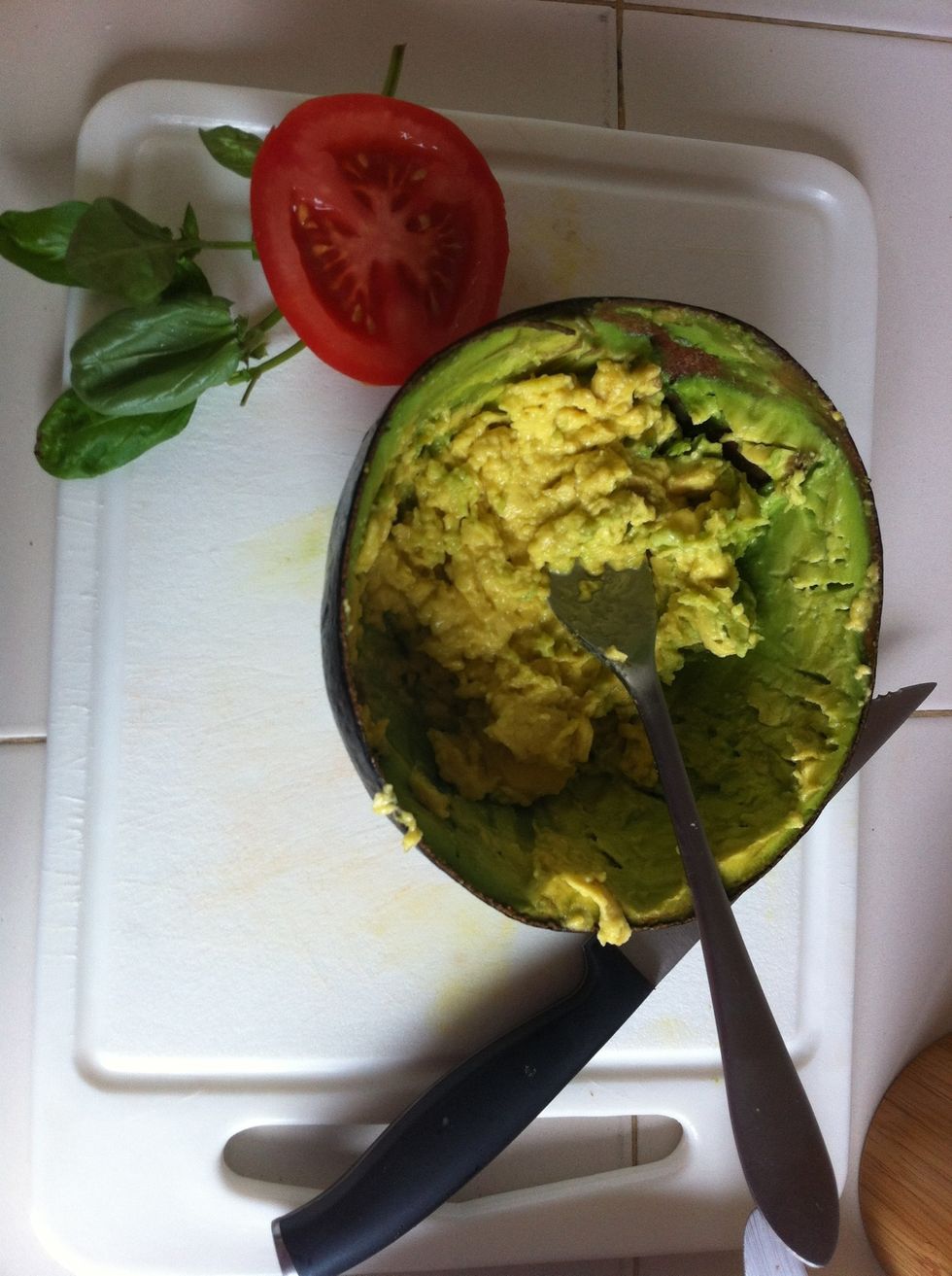 Prepare your avocado. I prefer mashing it so it stays on the bread better. Some people prefer it sliced.