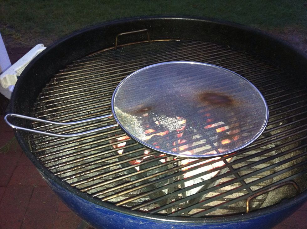 Prepare your BBQ as you would normally do. I've used a Weber BBQ  and charcoal brickets in this guide. Wait till you're ready to start grilling before placing the mesh on the BBQ.