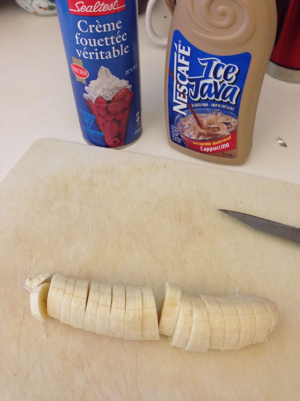 Prepare your condiments: bananas, chocolate syrup and whip cream