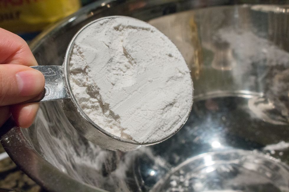 Prepare your dry ingredients. In a mixing bowl, add flour.