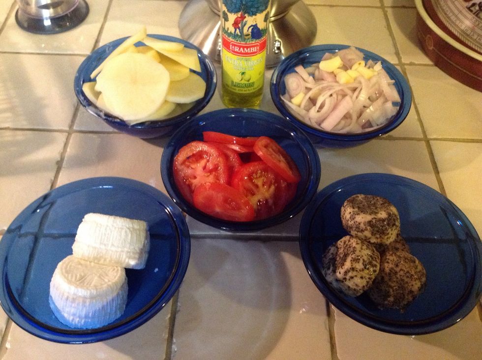 Prepare your ingrdients: thinly slice potato & tomatoes, slice onions, crush garlic, and remove the cheeslets from their retaining water