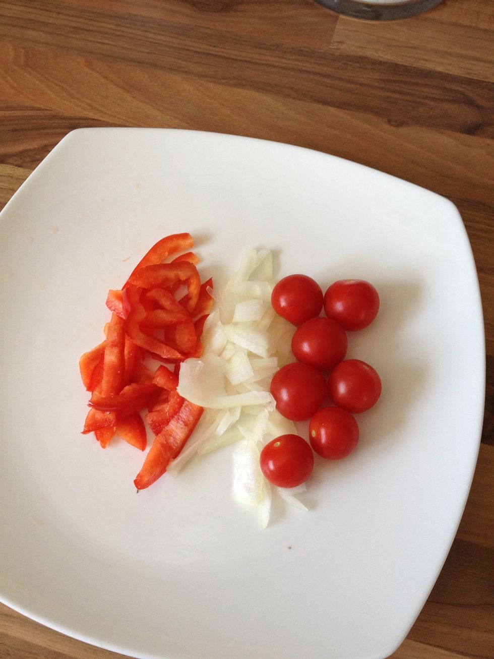 Prepare your vegetables. Cut and slice (into small pieces) the desired amount of onion and bell pepper, there is no need to use all of the vegetable here. Gather the small tomatoes also.