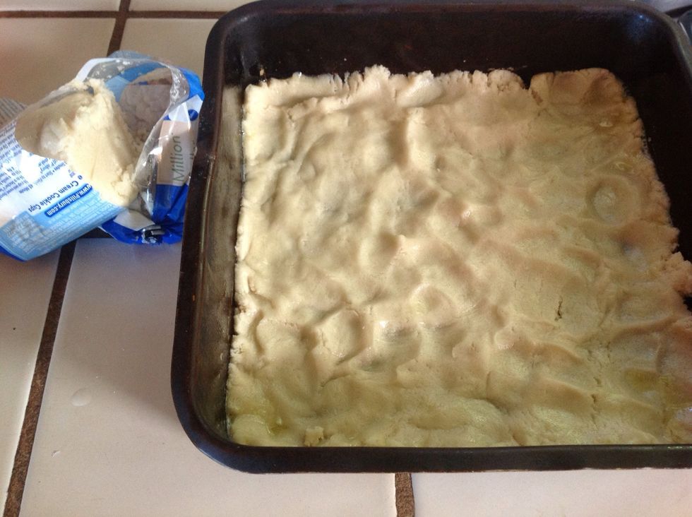 Press 2/3 of the cookie dough into the bottom of an 8x8 baking pan.