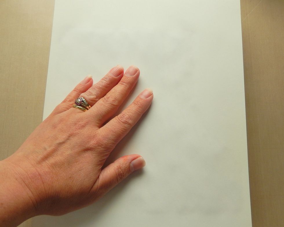 Press a blank piece of copy paper over the top of the paste covered canvas and press down.