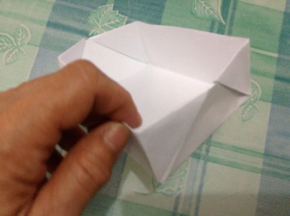 Press along the corner and bottom creases to shape the box.