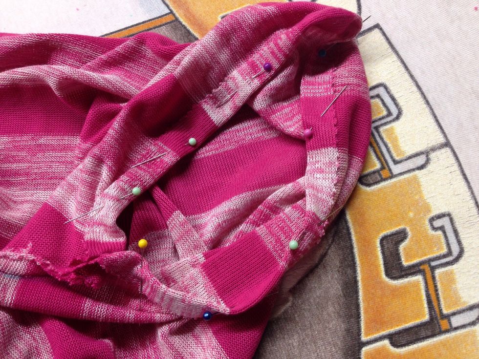 Press and pin 5/8 seam allowance around both arm holes.