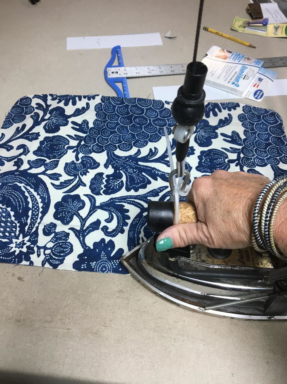 Press around all 4 sides. We serged the edge all the way around on ours but it isn't necessary.